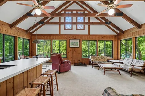 a room with a large window and chairs