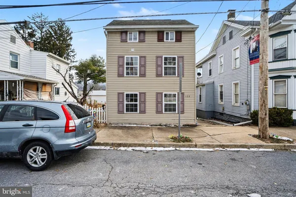 a view of a car parked in front of a house