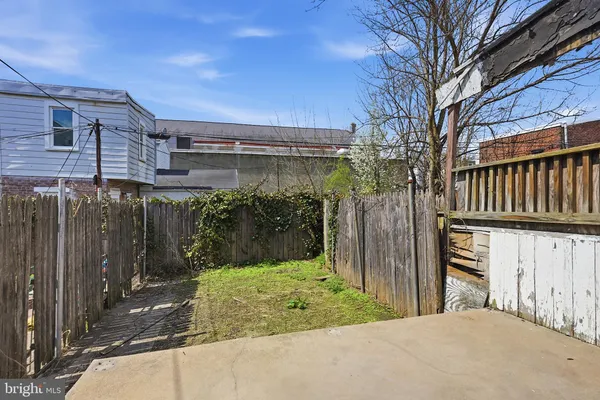a view of a house with a wooden fence