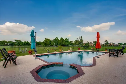 a view of a garden with a building in the background