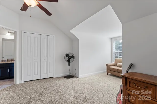 an empty room with a ceiling fan and a window
