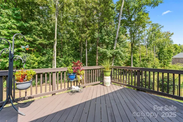 a view of a deck with two chairs and wooden floor