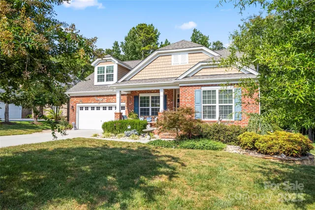 a front view of a house with garden and porch