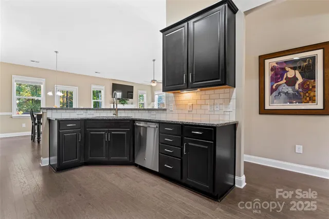 a spacious bathroom with a granite countertop double vanity and a mirror