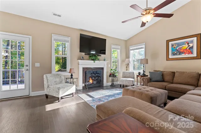a living room with furniture fireplace and a flat screen tv