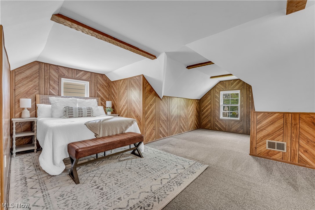 1828 South Green Road Cleveland, OH 44121 - Photo 22 of 30 Carpeted bedroom with lofted ceiling with beams and wooden walls