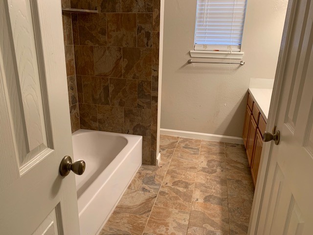 422 Nursery Road Spring, TX 77380 - Photo 14 of 26 a bathroom with a tub a window and a shower