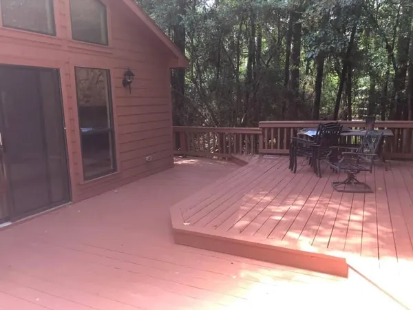 a view of a deck with chairs and a yard