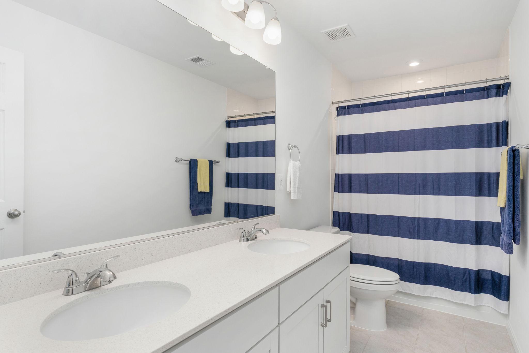 6371 Pointer Lane King George, VA 22485 - Photo 20 of 38 a bathroom with a sink a toilet a shower and a mirror