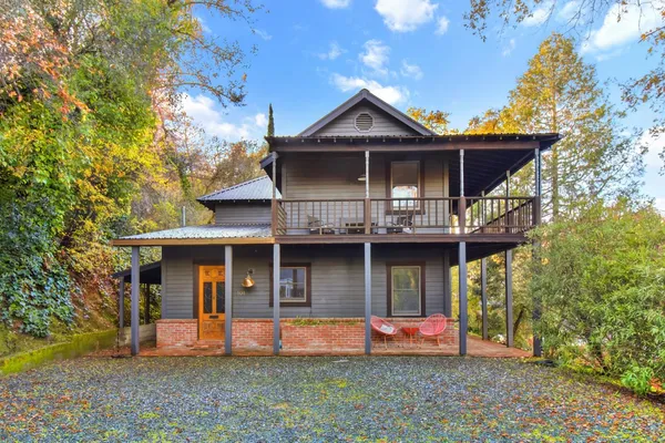 a front view of a house with an outdoor seating
