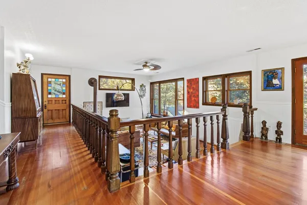 a living room with furniture wooden floor and a flat screen tv