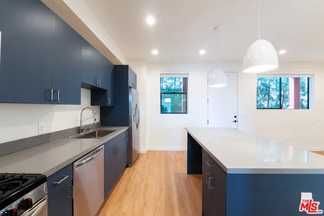 a bathroom with a granite countertop toilet a sink and shower