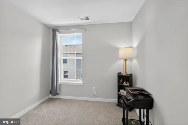 a view of a livingroom with furniture and a lamp