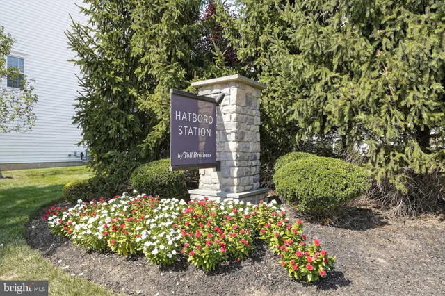 a sign that is sitting in front of flowers