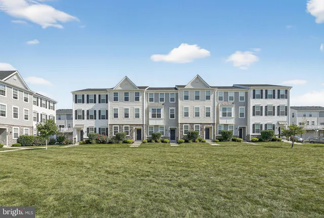 a view of building with yard and green space