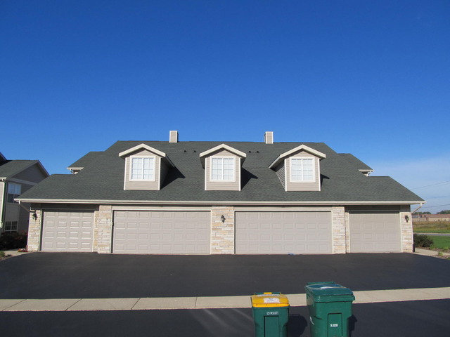 983 Kelly Lane, Unit 983 Sycamore, IL 60178 - Photo 23 of 25 a front view of a house with a yard