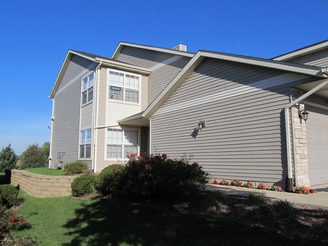 983 Kelly Lane, Unit 983 Sycamore, IL 60178 - Photo 24 of 25 a front view of a house with a yard