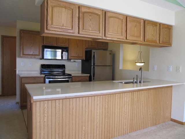 983 Kelly Lane, Unit 983 Sycamore, IL 60178 - Photo 8 of 25 a kitchen with stainless steel appliances granite countertop a refrigerator and a sink