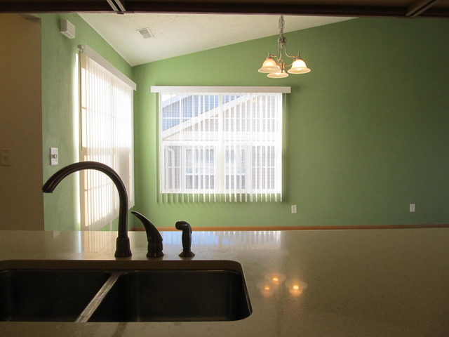 983 Kelly Lane, Unit 983 Sycamore, IL 60178 - Photo 10 of 25 a kitchen with a sink and a large window