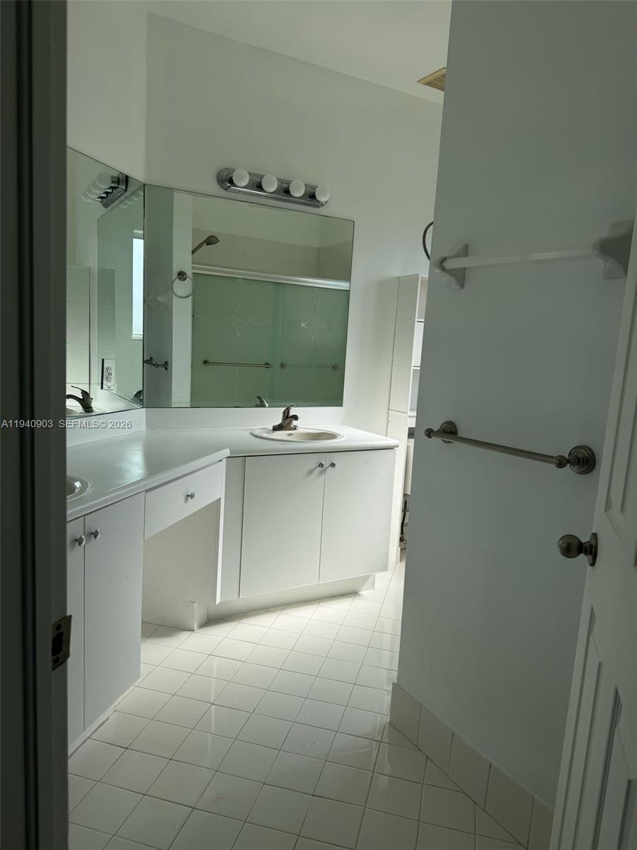 22547 Southwest 94th Path, Unit 22547 Cutler Bay, FL 33190 - Photo 15 of 20 a bathroom with a sink vanity and toilet