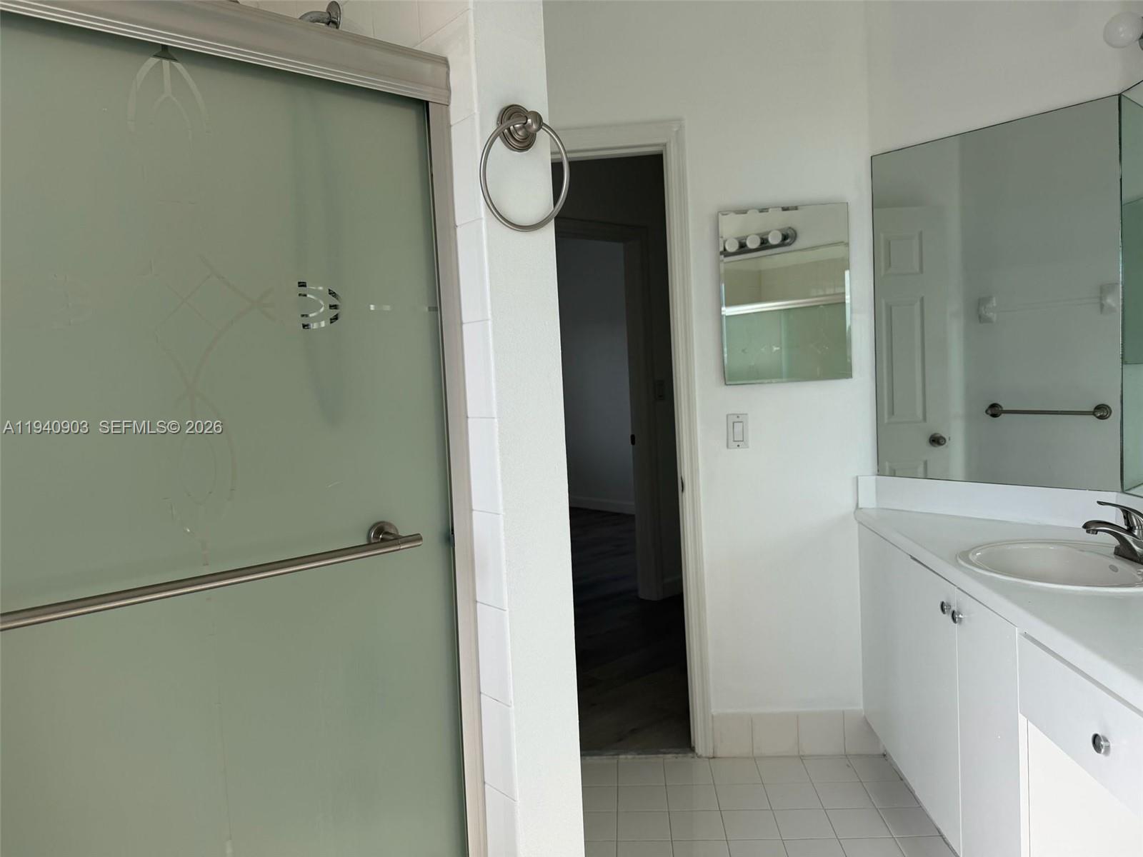 22547 Southwest 94th Path, Unit 22547 Cutler Bay, FL 33190 - Photo 16 of 20 a bathroom with a sink and shower