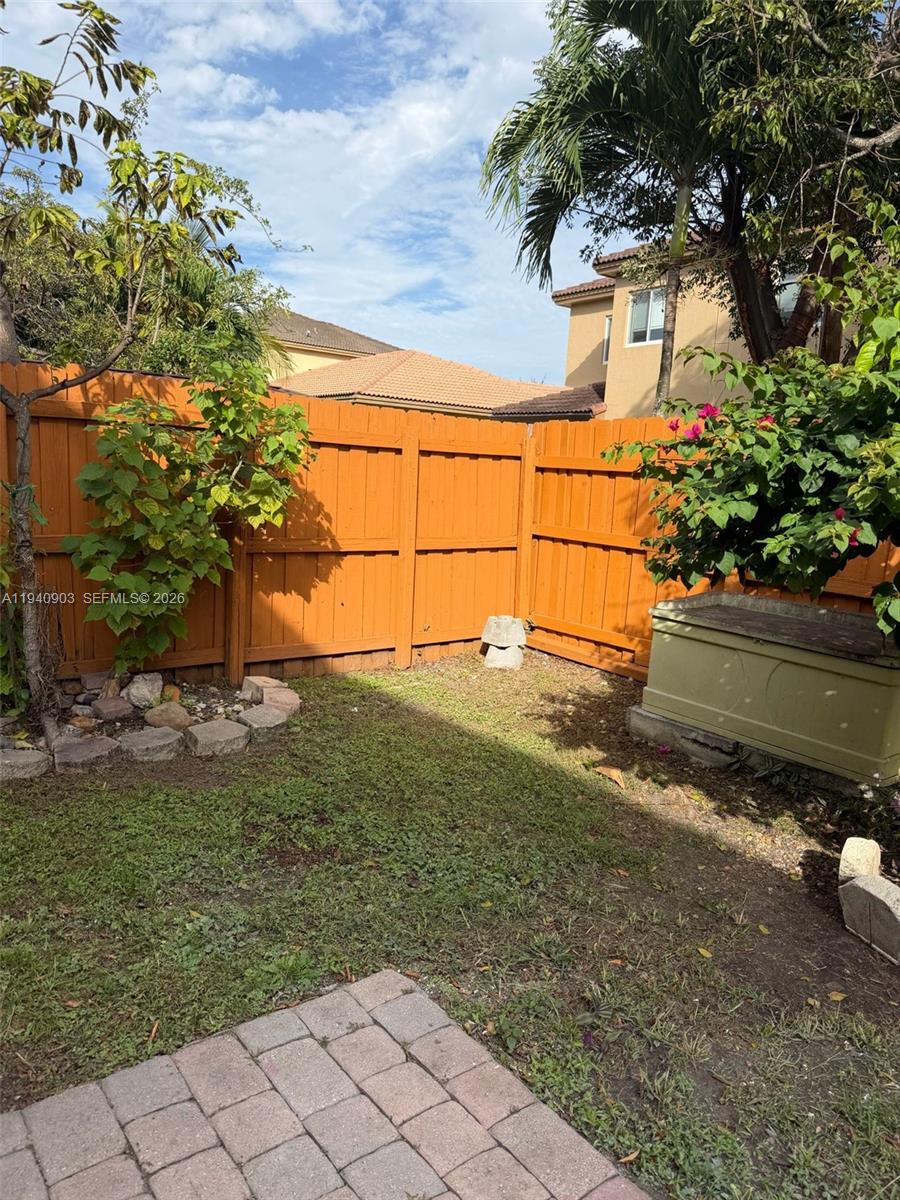 22547 Southwest 94th Path, Unit 22547 Cutler Bay, FL 33190 - Photo 19 of 20 a backyard of a house with lots of green space