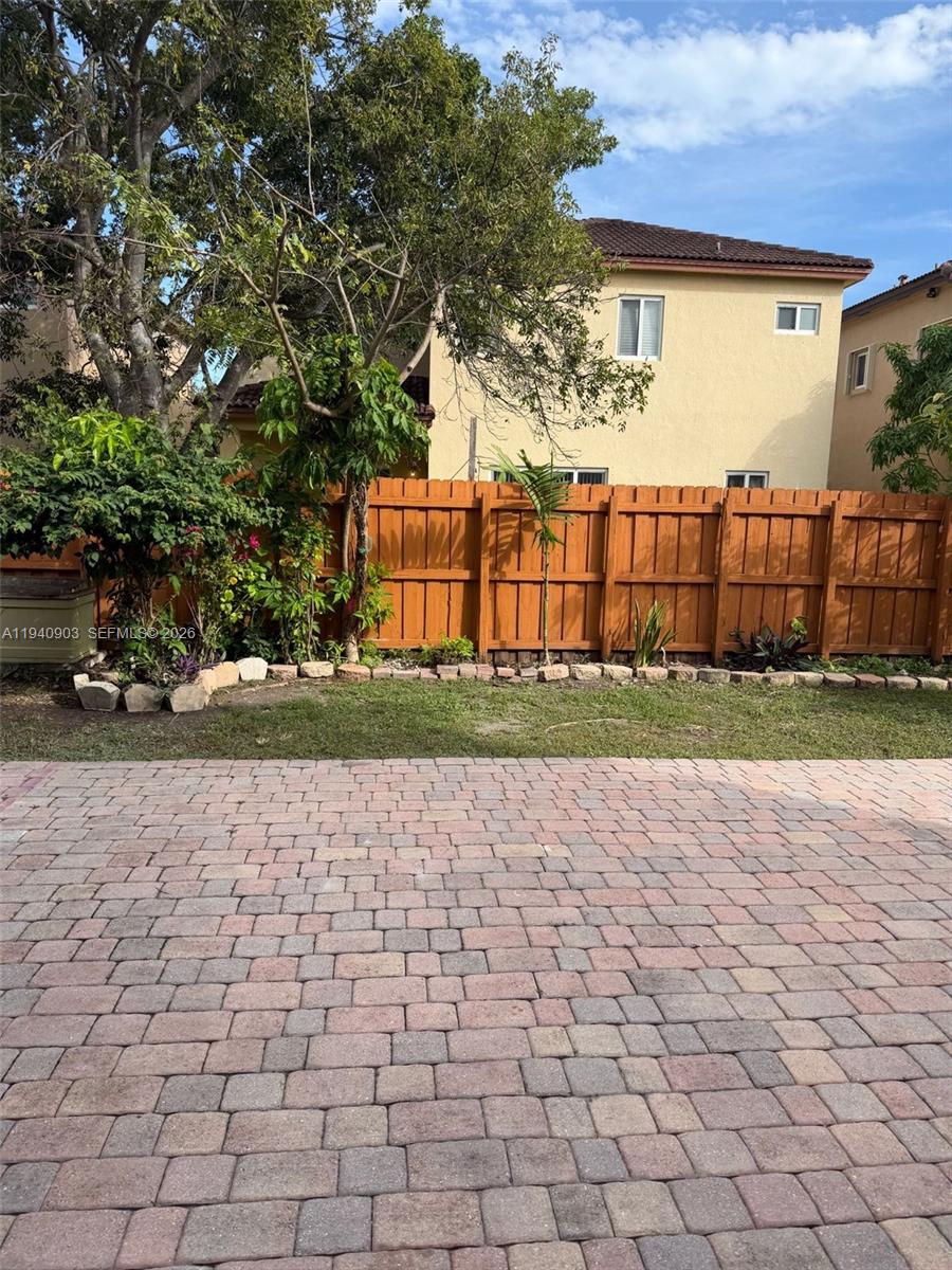 22547 Southwest 94th Path, Unit 22547 Cutler Bay, FL 33190 - Photo 20 of 20 a view of a yard with plants and trees