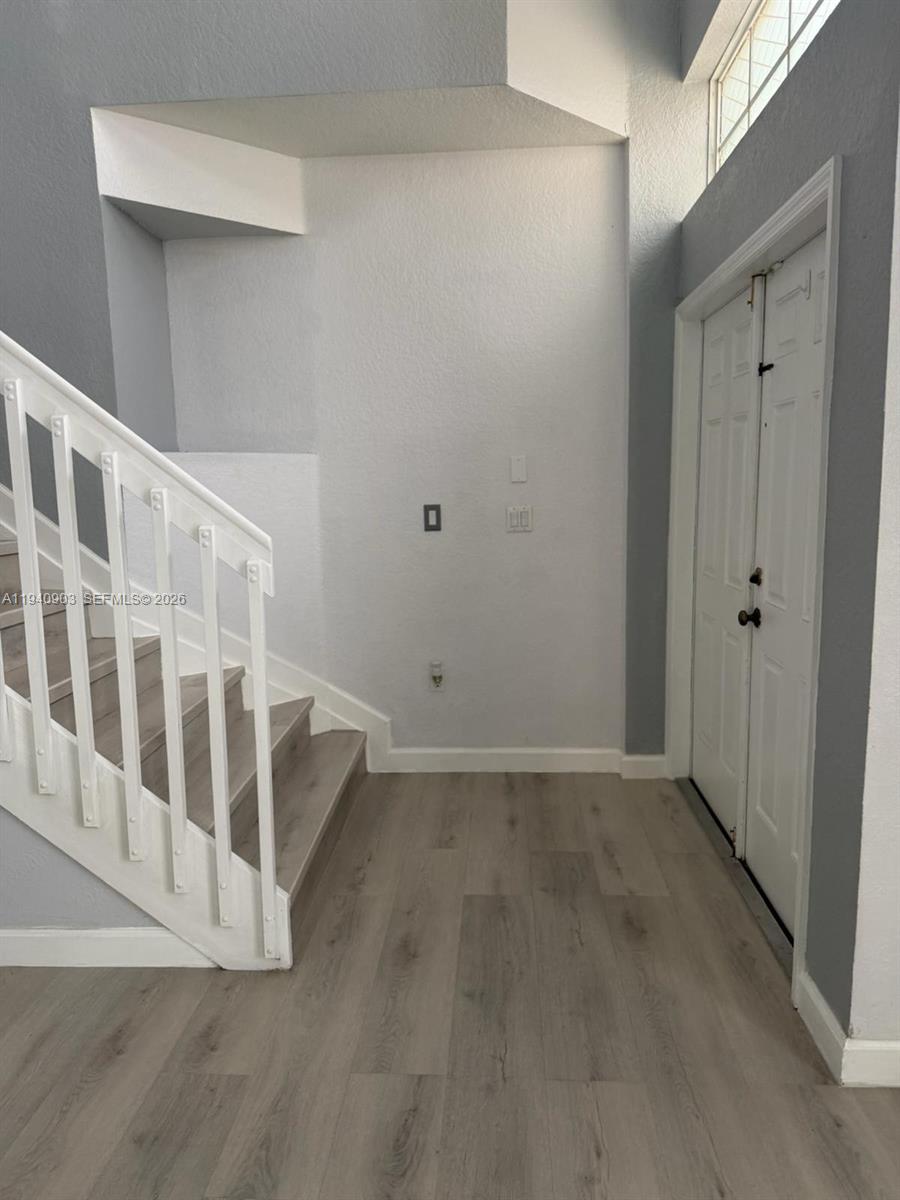 22547 Southwest 94th Path, Unit 22547 Cutler Bay, FL 33190 - Photo 2 of 20 a view of an entryway with wooden floor