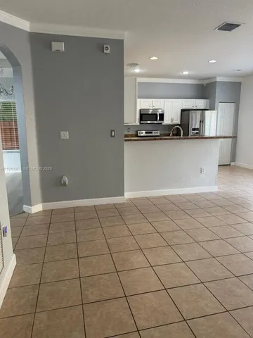 a view of a kitchen with a sink and cabinets