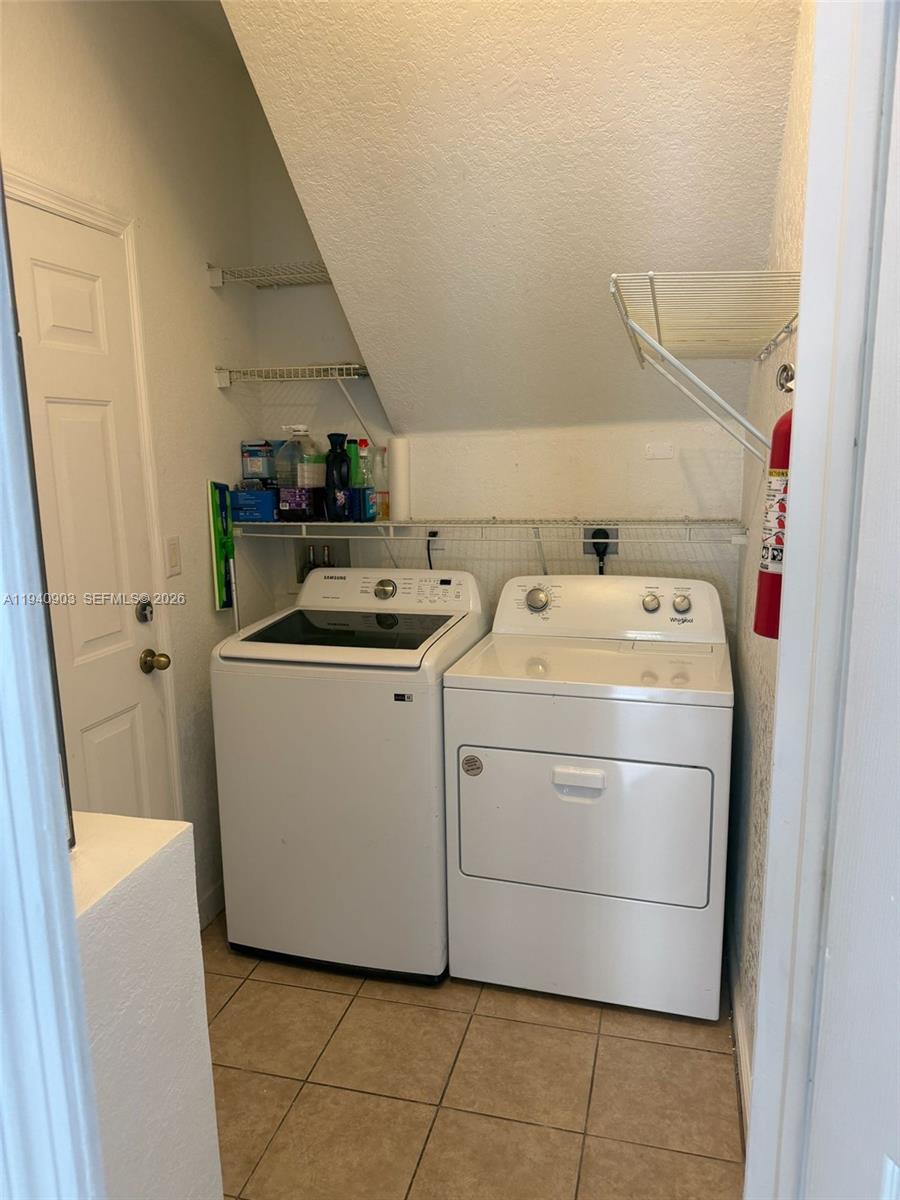 22547 Southwest 94th Path, Unit 22547 Cutler Bay, FL 33190 - Photo 7 of 20 a utility room with dryer and washer