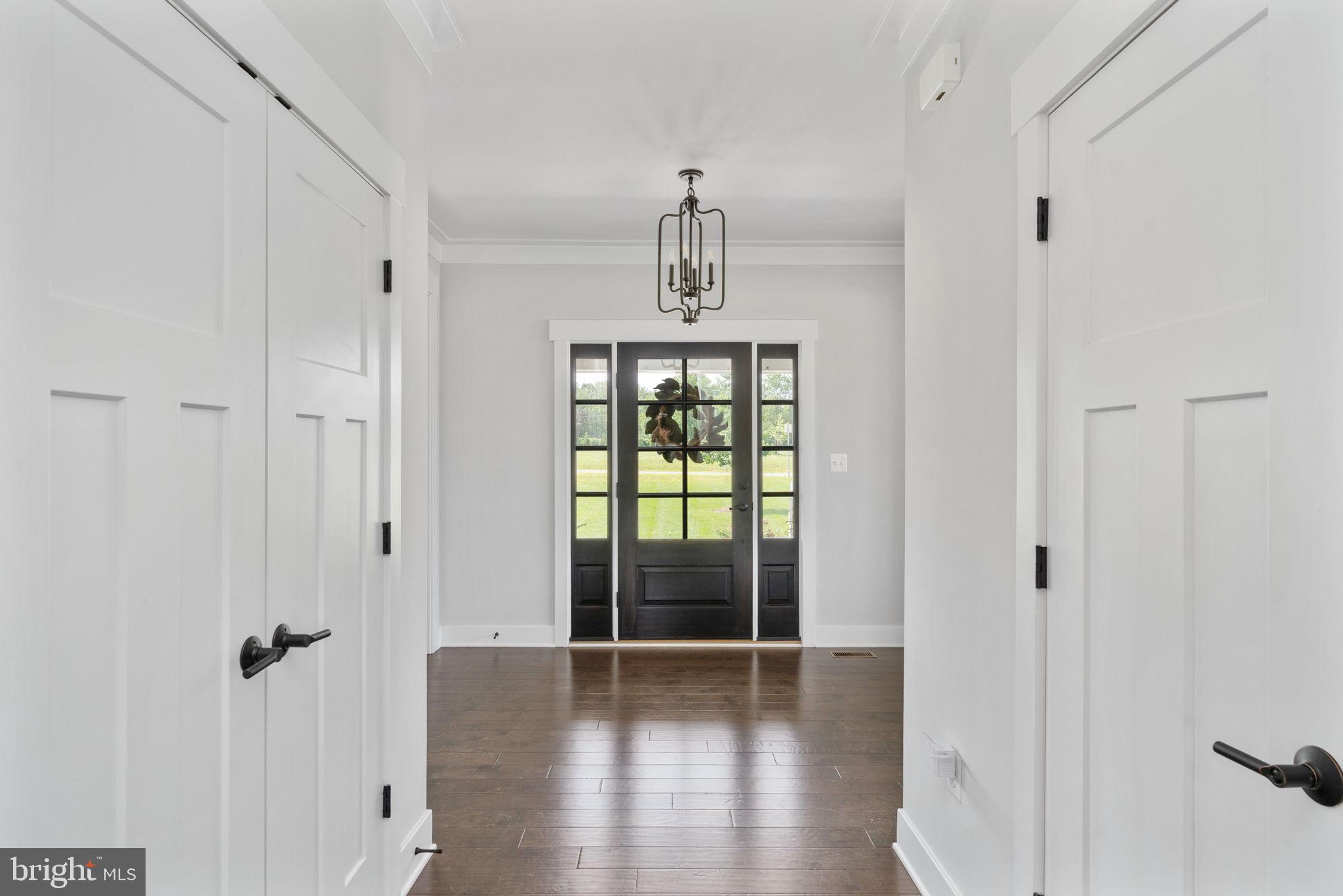 115 Saddle Ridge Lane Fredericksburg, VA 22406 - Photo 12 of 100 a view of a hallway with wooden floor and a chandelier