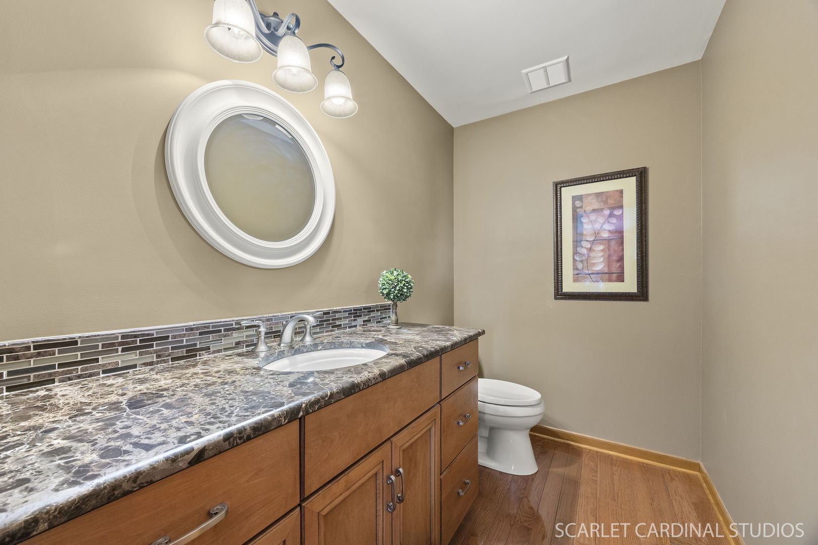 2565 Thornley Court Aurora, IL 60504 - Photo 17 of 59 a bathroom with a granite countertop toilet a sink and a mirror