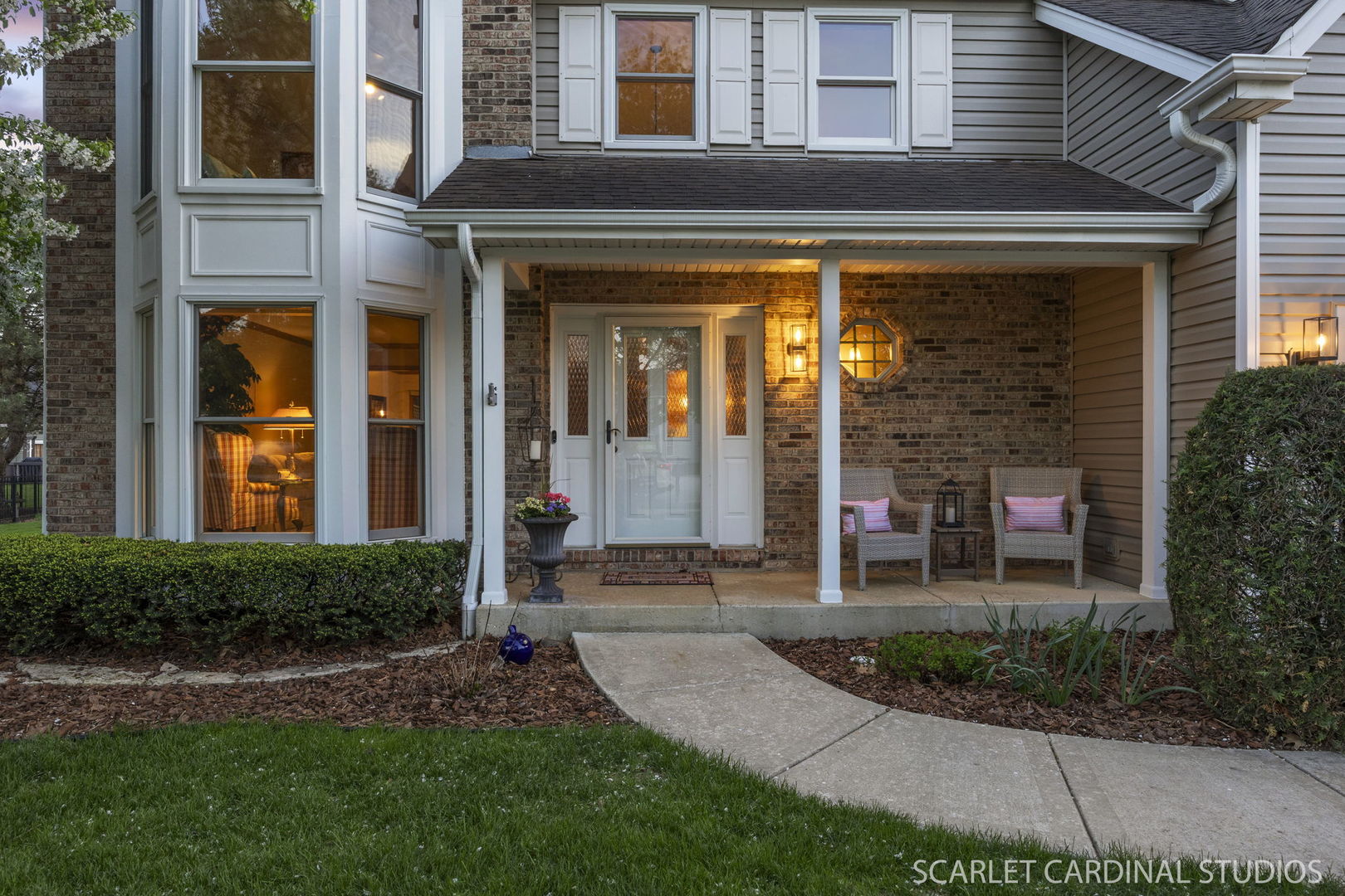 2565 Thornley Court Aurora, IL 60504 - Photo 35 of 59 a view of a house with brick walls and a yard with plants