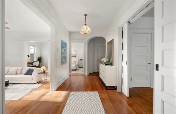 a living room with furniture and a wooden floor