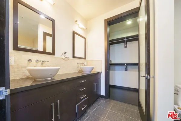 a bathroom with a double vanity sink and mirror