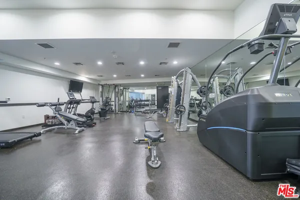 a gym room with lots of gym equipment