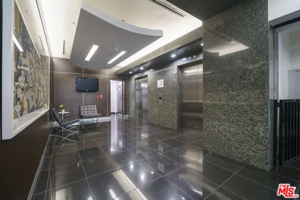 a lobby with furniture and a rug