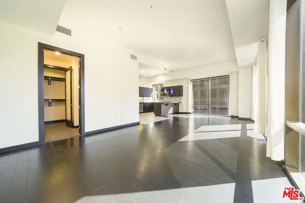 a view of a livingroom with wooden floor and furniture