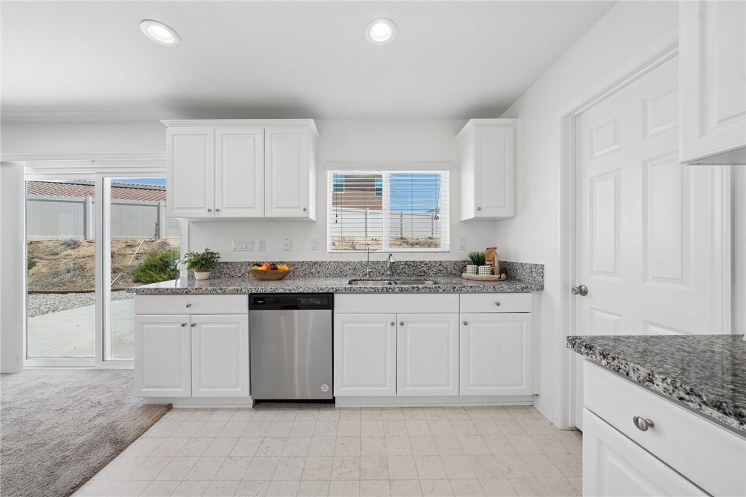 20130 Curaco Court Riverside, CA 92507 - Photo 16 of 43 Kitchen sink area with granite counters, dishwasher, and backyard views.
