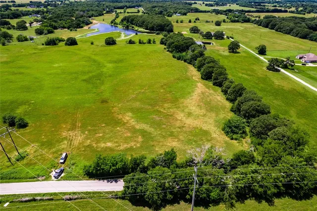 an aerial view of residential houses with outdoor space and swimming pool