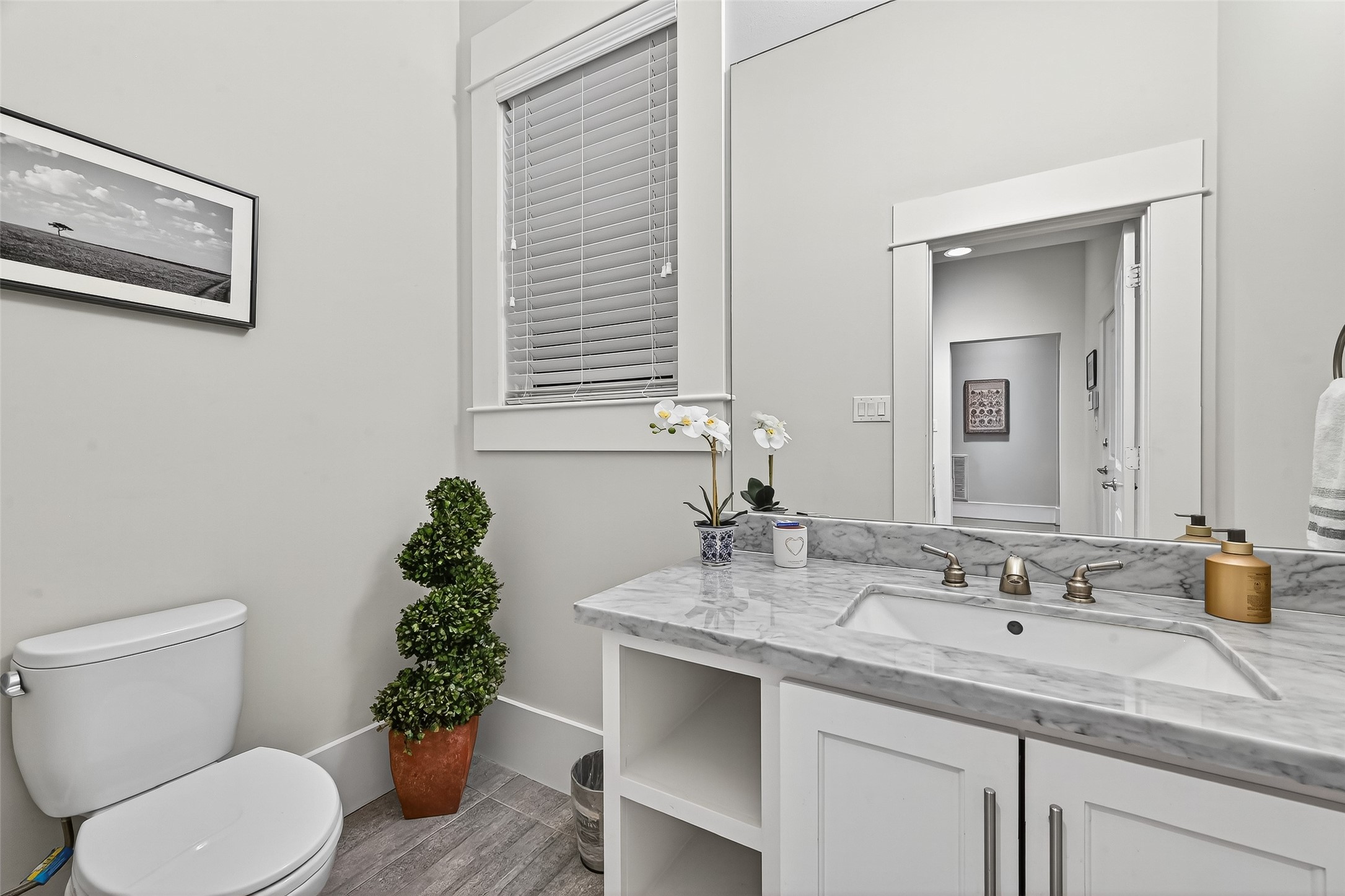 2217 West Main Street Houston, TX 77098 - Photo 20 of 31 a bathroom with a granite countertop sink and a toilet
