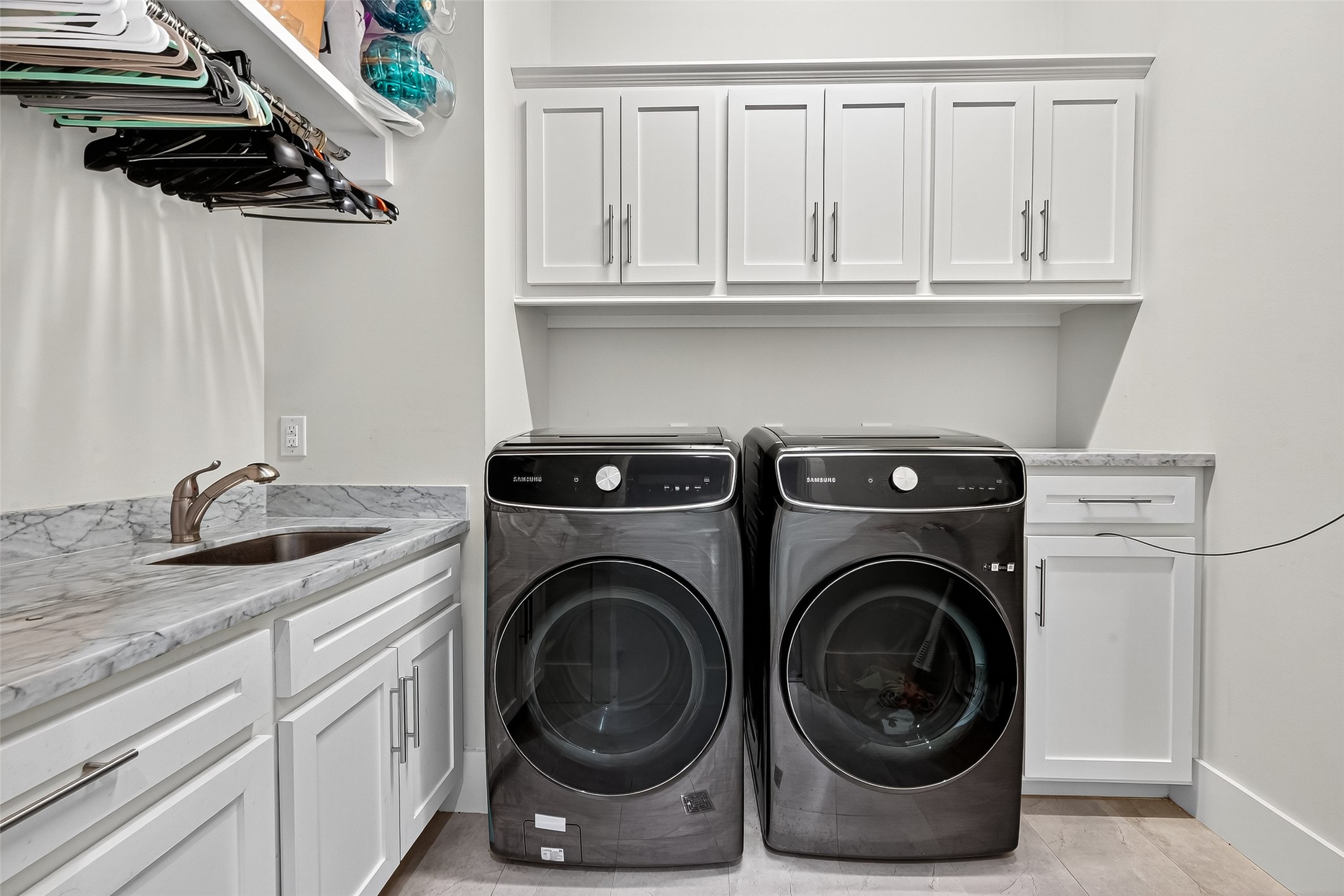 2217 West Main Street Houston, TX 77098 - Photo 21 of 31 a utility room with sink dryer and washer