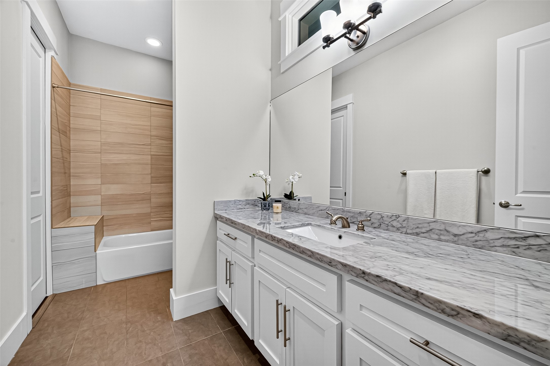 2217 West Main Street Houston, TX 77098 - Photo 23 of 31 a bathroom with a double vanity sink a mirror and a bathtub