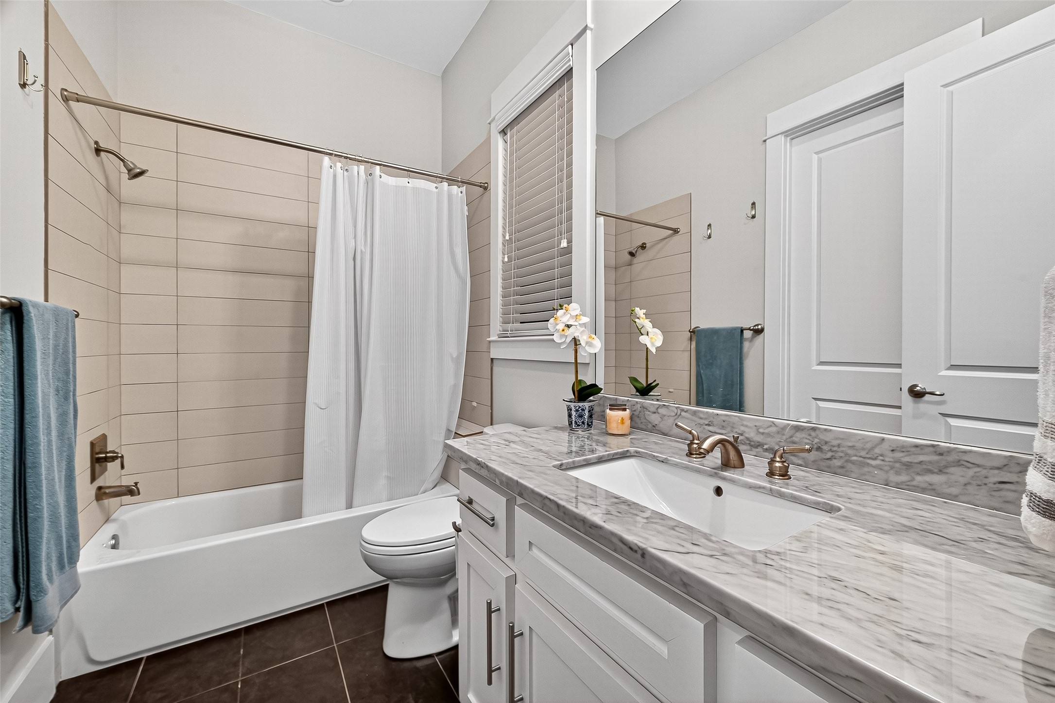 2217 West Main Street Houston, TX 77098 - Photo 27 of 31 a bathroom with a granite countertop sink toilet and shower