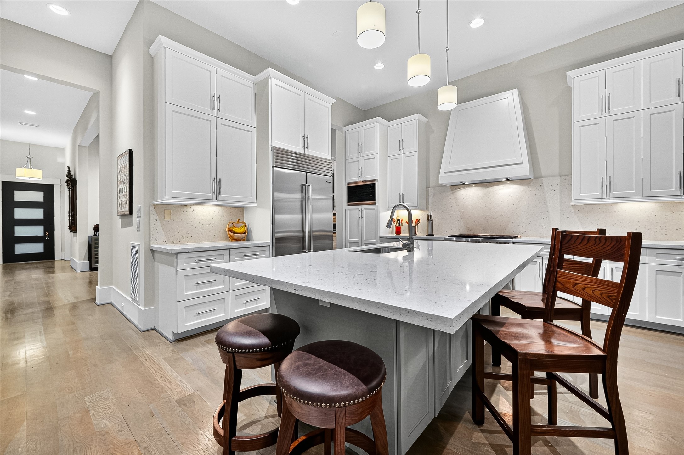 2217 West Main Street Houston, TX 77098 - Photo 2 of 31 a kitchen with a table chairs sink and cabinets