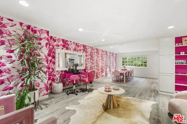 a living room filled with furniture and a potted plant