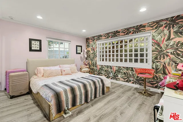 a spacious bedroom with a bed and a chandelier