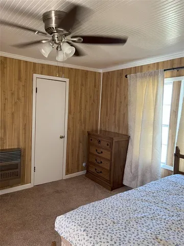 a bed sitting in a room next to a window