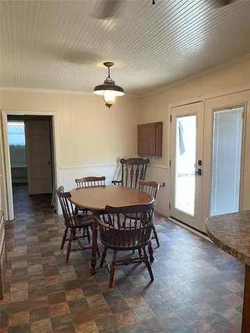 a view of a refrigerator with wooden cabinets