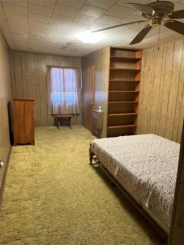 a view of a yard with wooden fence